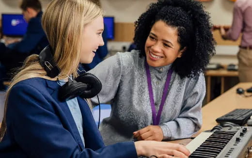 a few young women working on a computer