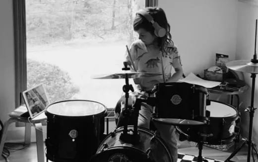 a girl playing the drums