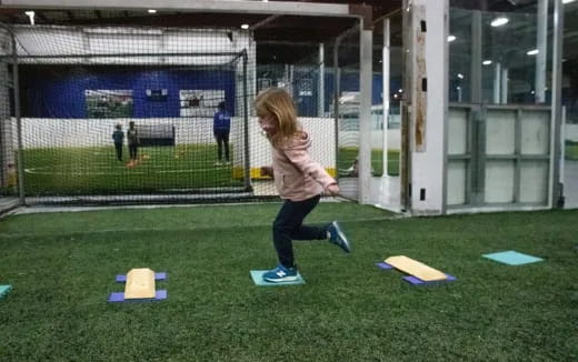 a girl running on a field