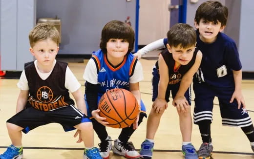 a group of boys playing basketball