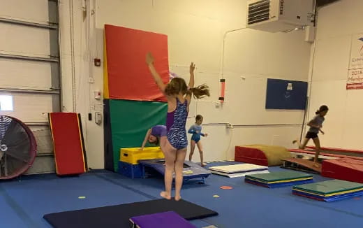 a group of children exercising in a room