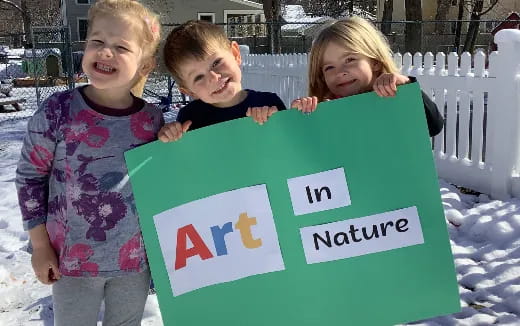 a group of children holding a sign