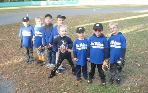 a group of children in blue uniforms