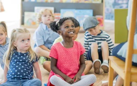 a group of children sitting in a classroom