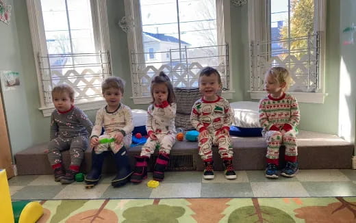 a group of children sitting on a bench