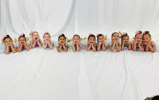 a group of girls in a white tent