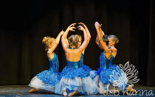 a group of girls in blue dresses