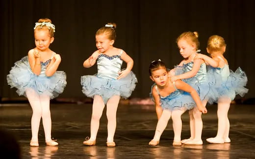 a group of girls in blue dresses