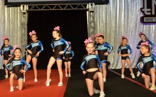 a group of girls in blue uniforms