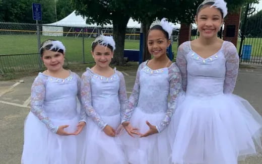 a group of girls in dresses