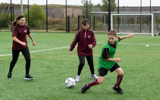 a group of girls playing football