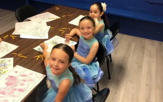a group of girls sitting at a table