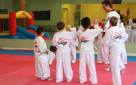 a group of kids in karate uniforms