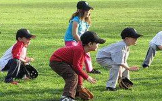 a group of kids playing baseball