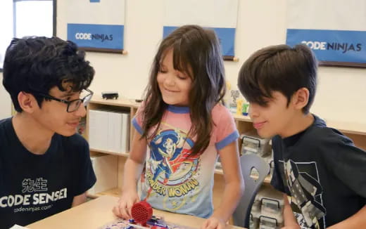 a group of kids playing with a toy