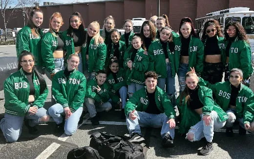 a group of people in green jackets