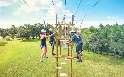 a group of people on a wooden structure outside