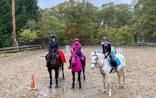 a group of people riding horses