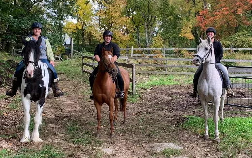 a group of people riding horses