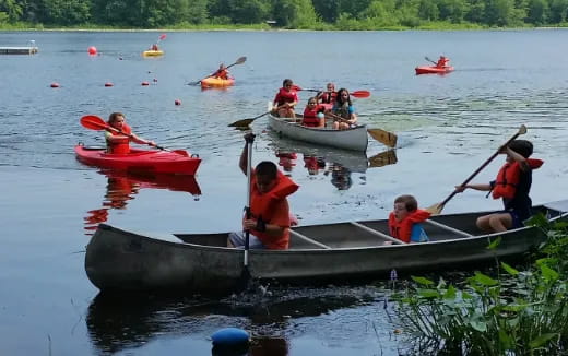 a group of people rowing boats