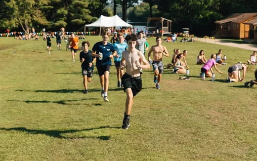 a group of people running on a field