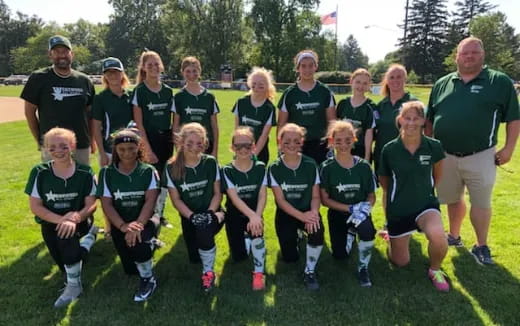 a group of people wearing green shirts