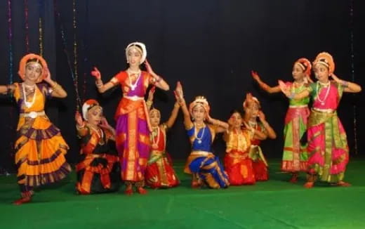 a group of women in colorful dresses