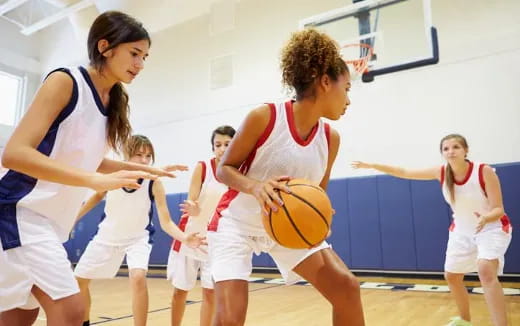 a group of women playing basketball