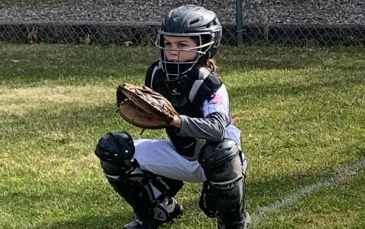 a kid catching a baseball