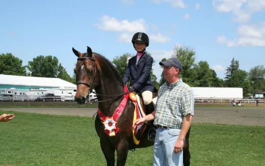 a man and a boy on a horse