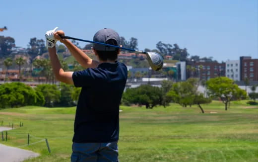 a man swinging a golf club