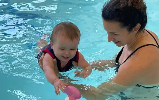 a person and a baby in a pool