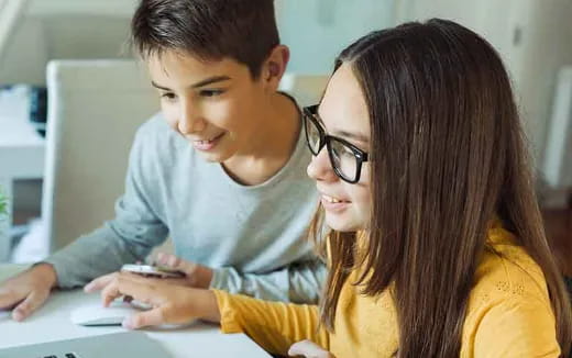 a person and a boy looking at a phone