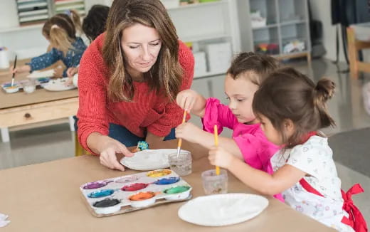 a person and a child sitting at a table with food