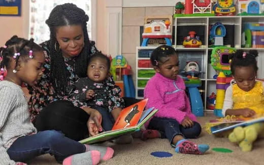 a person and several children playing with toys