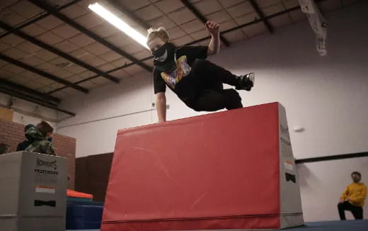 a person doing a trick on a red object