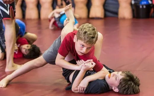 a person helping a boy on the floor