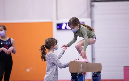 a person helping a girl with a box