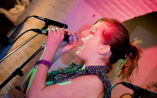 a person singing into a microphone