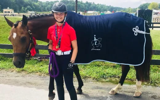 a person standing next to a horse