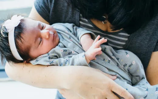 a woman holding a baby