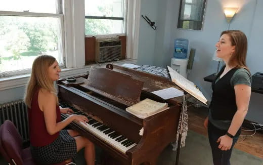 a woman playing a piano