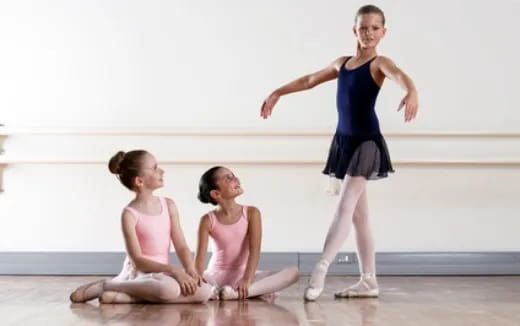 a woman standing on a man's back