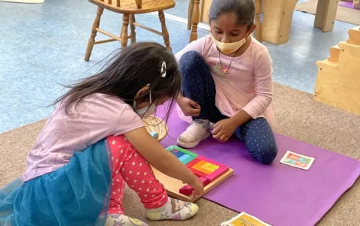 a young girl and a young girl playing with a toy