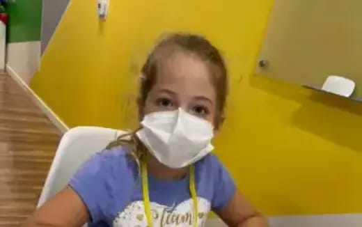 a young girl wearing a mask