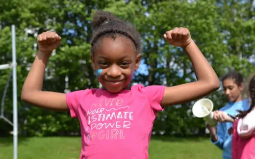 a young girl with her hands up