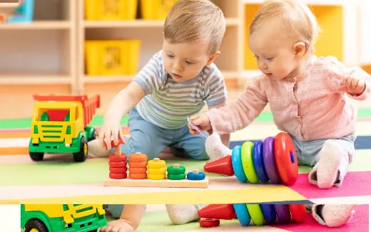 two babies playing with toys