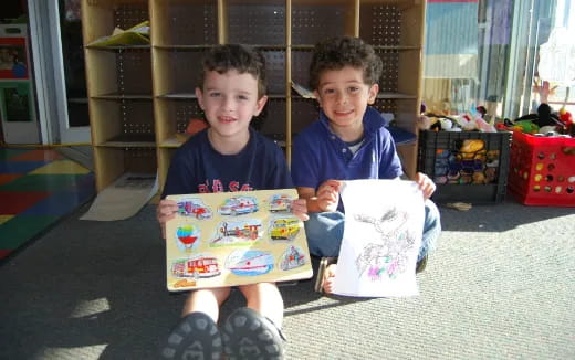 two boys sitting on the floor