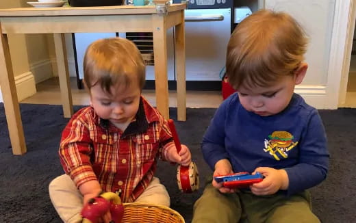two boys sitting on the floor