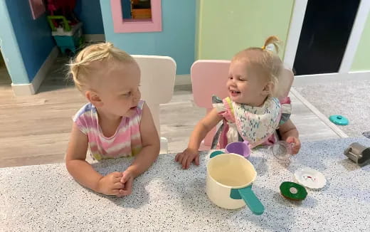 two children sitting on the floor